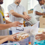 People packing clothes and food into donation boxes