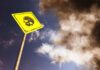 Deadly Colosseum Tragedy Sparks Urgent Probe Yellow warning sign with skull symbol under dramatic cloudy sky