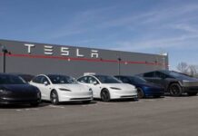 Tesla’s Makes BIG Bet Before BIG Reveal A lineup of Tesla cars parked in front of a Tesla building