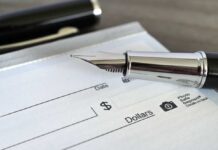 Record Paycheck Shock Close-up of a fountain pen poised over a blank check