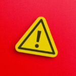 Killer Mosquito Sneaks In — Two Workers Dead Yellow warning sign with exclamation mark on red background