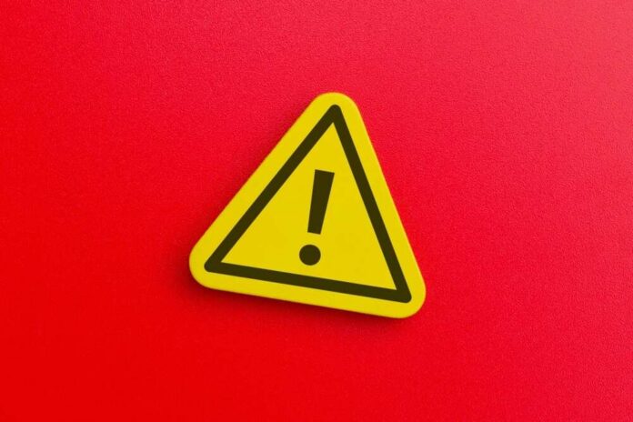 A,Yellow,Triangular,Warning,Sign,With,An,Exclamation,Mark.,Danger, Yellow warning sign with exclamation mark on red background