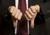 New CRACKDOWN Impacts THIS That Americans Want? Two hands showing thumbs down in a suit.