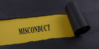 Torn black paper revealing the word 'MISCONDUCT' on yellow paper