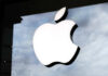 Illuminated Apple logo on a glass storefront