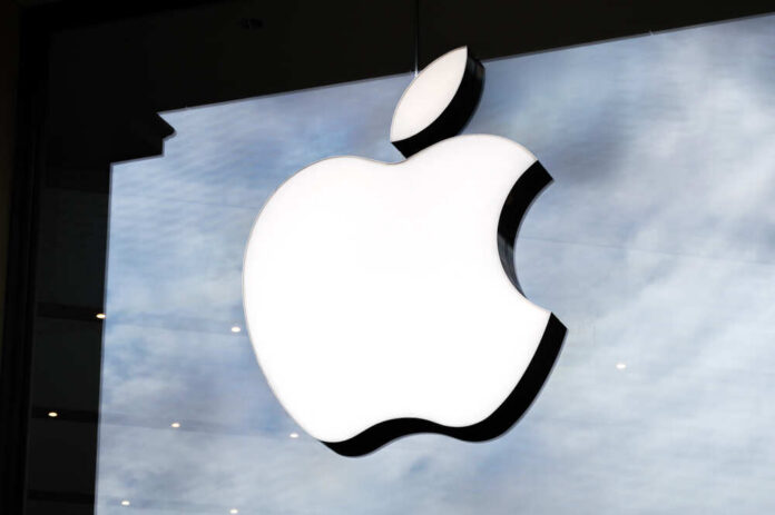 Illuminated Apple logo on a glass storefront