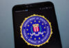 FBI Boss Drops Ring – Internet Spirals FBI logo displayed on a smartphone screen