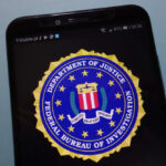 FBI Boss Drops Ring – Internet Spirals FBI logo displayed on a smartphone screen