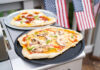 Beloved Pizza Gone For Margins Homemade pizzas on grill trays with vegetable and pepperoni toppings