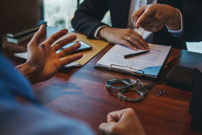 Handcuffs and documents on a desk during discussion.