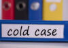 Cold-Case Shock: Suspect Back In Cuffs (VIDEO) Blue binder labeled 'cold case' with other colored binders in the background