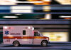 Ambulance driving through city street at speed