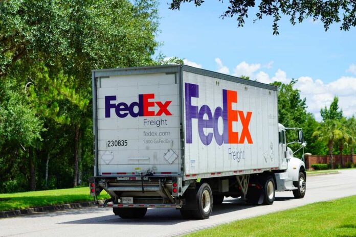 FedEx freight truck driving down a suburban street