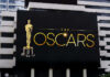 From Unknown To Oscar – And A Final Bow Oscars billboard on a city building exterior wall