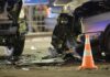 Car crash scene with two damaged vehicles and an orange traffic cone