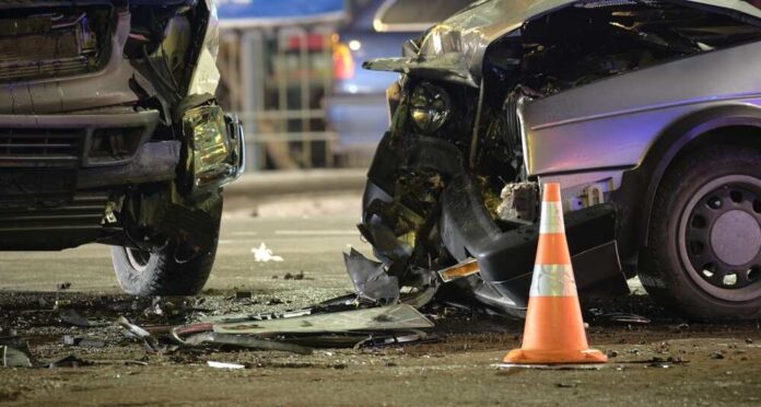 Cars,Crashed,Heavily,In,Road,Accident,After,Collision,On,City Car crash scene with two damaged vehicles and an orange traffic cone