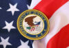 DOJ Case SLAMMED Department of Justice seal on American flag.