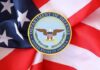Department of Defense emblem on an American flag background