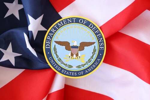 Department of Defense emblem on an American flag background