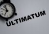 Ultimatum Shocks The West A black alarm clock next to the word 'ULTIMATUM' on a gray background