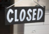 State Shuts Daycare After THIS? A black sign with the word 'CLOSED' painted in white letters